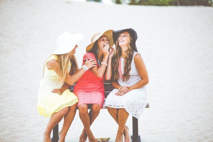 women-lauging-on-beach